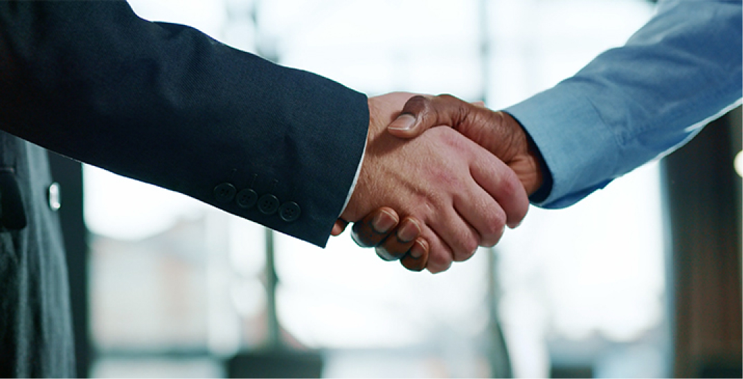 Two people shaking hands.