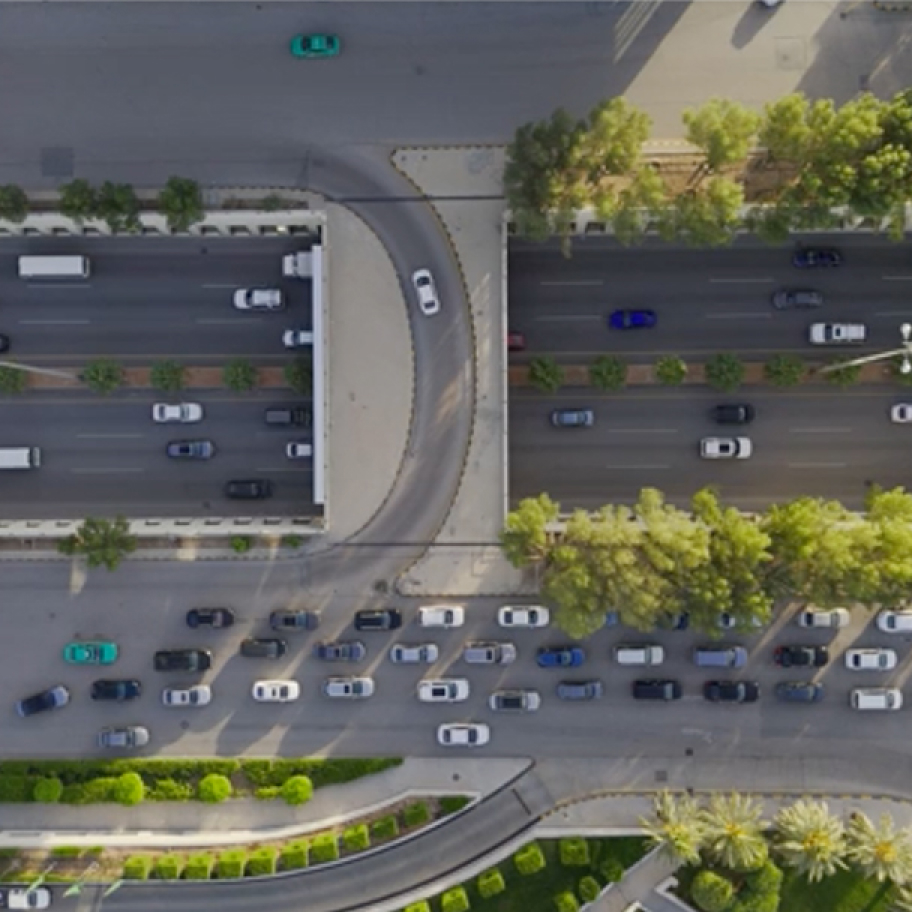 Aerial view of a busy city intersection with cars.