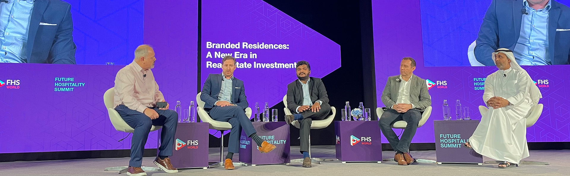 A group of businessmen in a conference on a stage