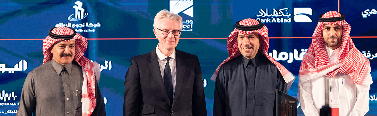 Group photo of four representatives from New Murabba Development Company at the 2024 Restatex exhibition in Riyadh, Saudi Arabia