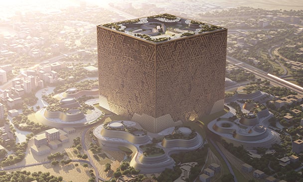  A futuristic cubic building with an intricate patterned facade towering above a modern cityscape, accompanied by flowing and organically shaped structures at its base, basking in warm sunlight.